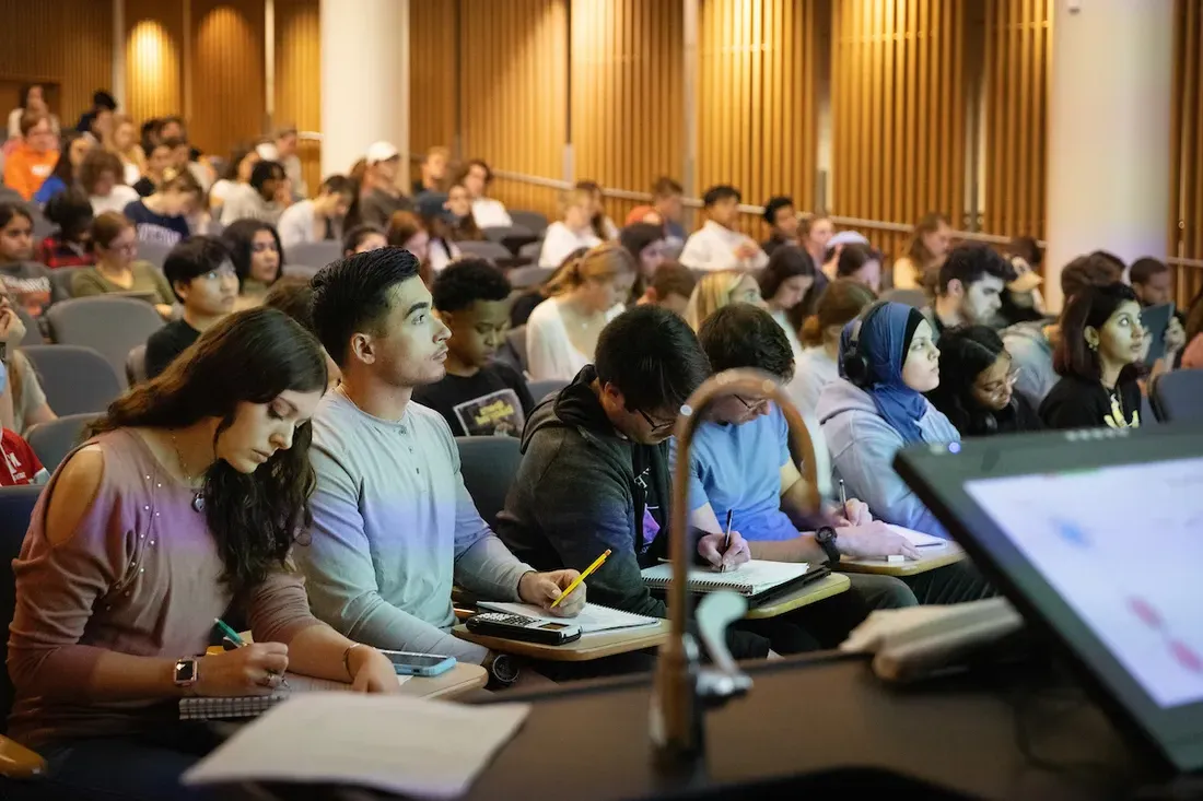 Students sitting in lecture hall.